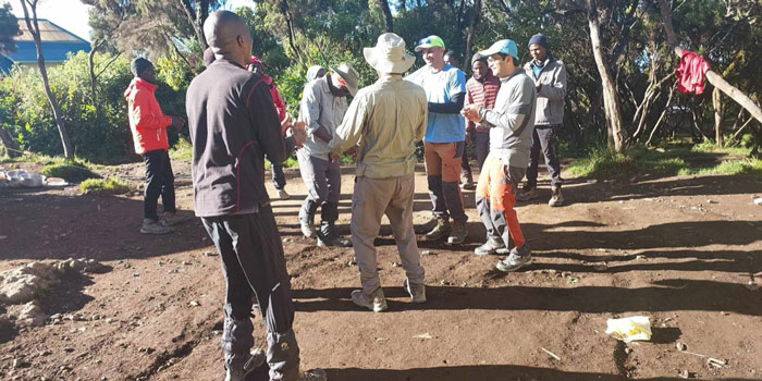 Clients and porters celebrating the successful climb of Kilimanjaro